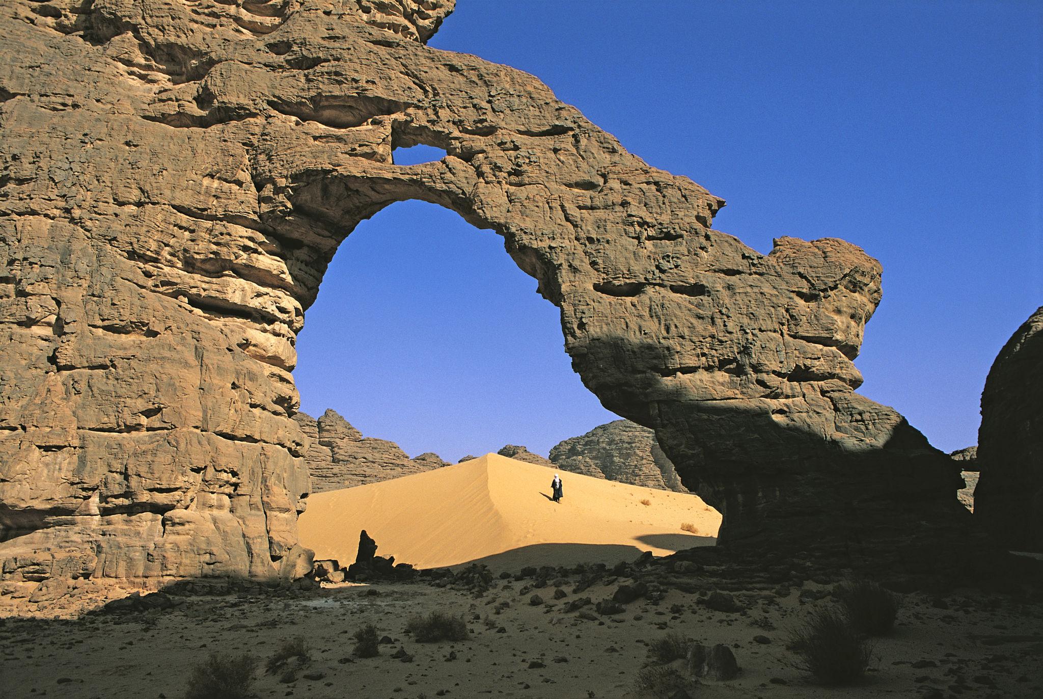 Tuareg rider crossing the dunes of Tassili n'Ajjer in the Sahara Desert - Algeria eSIM
