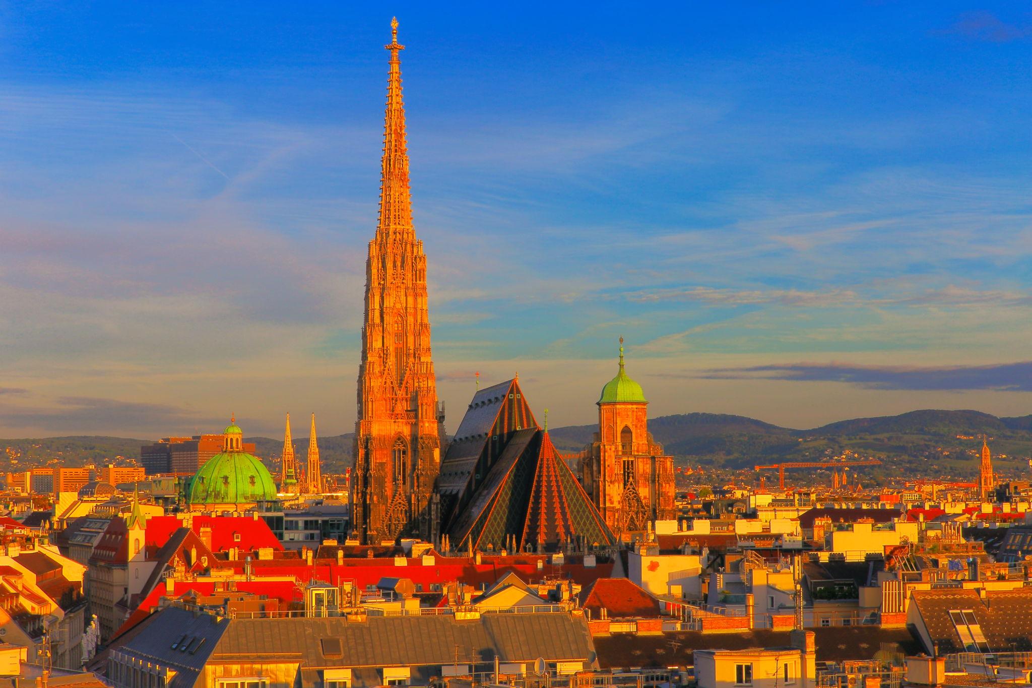 View of the bove Vienna Cityscape and St. Stephen's Cathedral roof, urban skyline at sunset - Austria eSim