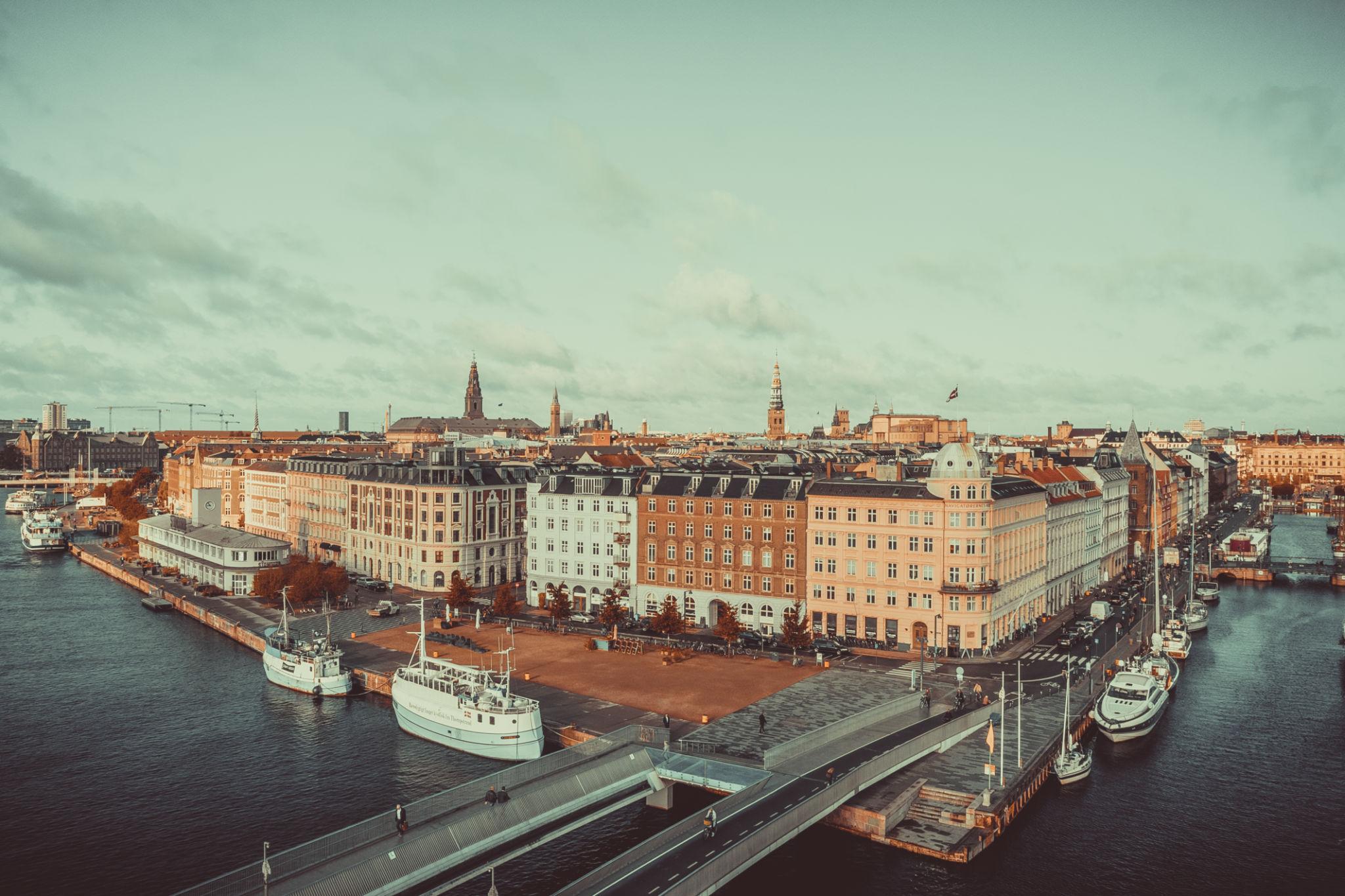 View of the Copenhagen skyline from above, Nyhavn historical pier port and canal with color buildings and boats in the old town of Copenhagen - Denmark eSim