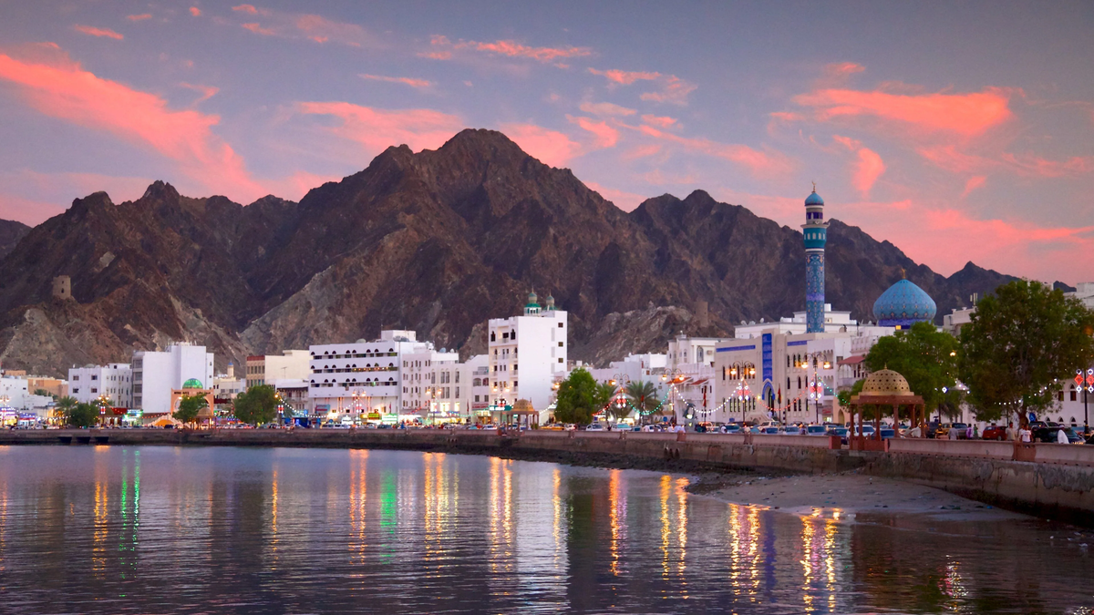 Muscat coastline and mosque skyline at dusk - Oman eSIM
