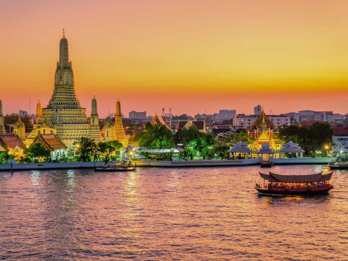 Wat Arun temple at sunset along the Chao Phraya River - Thailand eSIM